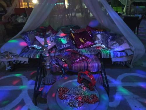 a bed in a room with purple and green lights at Anatoli Hotel in Agia Marina Aegina
