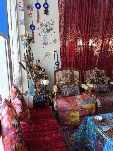 a living room with a couch and a table at Anatoli Hotel in Agia Marina Aegina