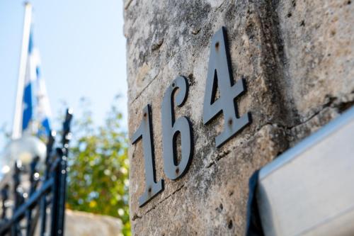 a sign on the side of a building with the number at Halepa Hotel in Chania Town