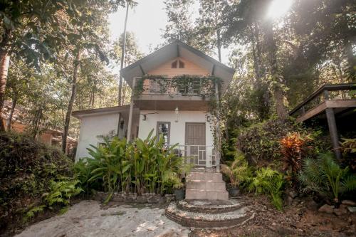 a small house in the middle of a forest at Cozy Huts in Trat