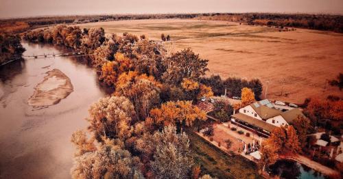 an aerial view of a house next to a river at Pensiunea Lunca in Arad