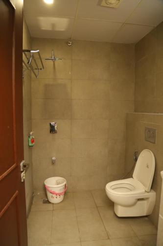 a bathroom with a toilet and a bucket at Vishnu Paradise in Mohammadnagar