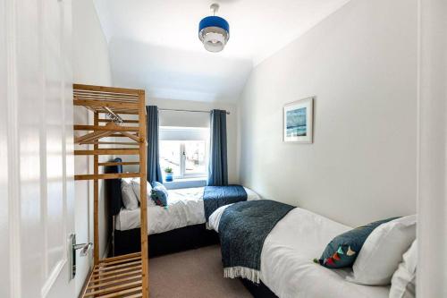 a bedroom with two bunk beds and a ladder at NORTH BEACH HOUSE - 3 Bedroom Fully Equipped Spacious House Perfect for Family Getaways in Bridlington in Bridlington