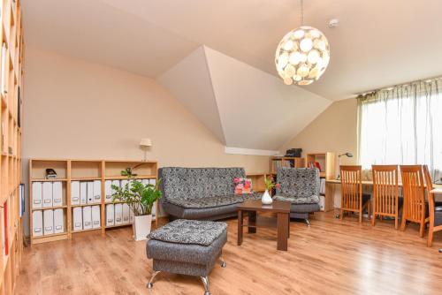 a living room with a couch and chairs and a table at Guest House Pasaulio Krastas in Palanga