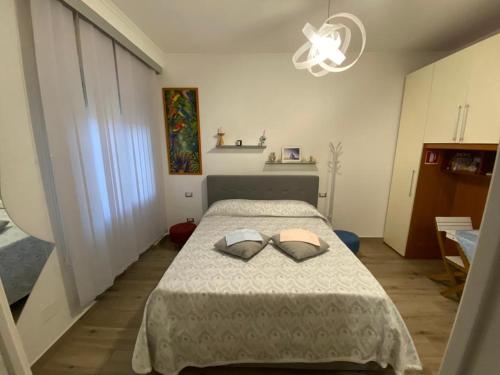 a bedroom with a bed with two pillows on it at Sissi B&B in Pozzuoli