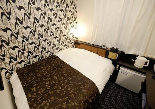 Postel nebo postele na pokoji v ubytování APA Hotel Nagano