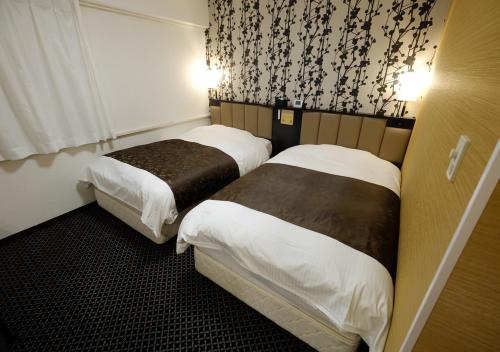 Postel nebo postele na pokoji v ubytování APA Hotel Nagano