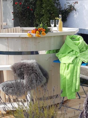 a bench with a table with a furussion at Gîte La petite maison horlogère et jacuzzi , raquettes in Les Fontenelles