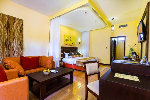 a hotel room with a bed and a couch at Lake Bogoria Spa Resort in Marigat