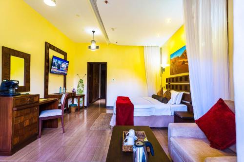a hotel room with a bed and a couch at Lake Bogoria Spa Resort in Marigat