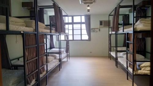 a room with a bunch of bunk beds at 想巷背包客棧 in Hsinchu City