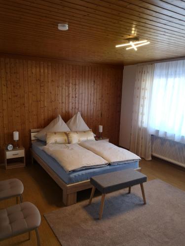 a bedroom with a bed and a table in it at Ferien am Wald in Baiersbronn