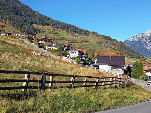 a hill with a fence on the side of a road at Ferienwohnung Regensburger in Wenns