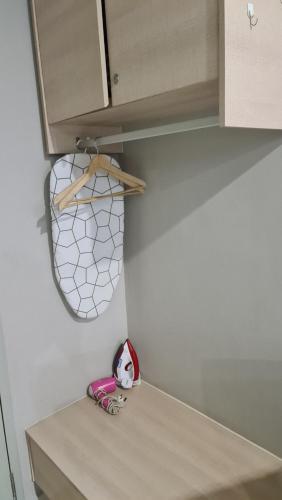 a stuffed animal is sitting on a shelf in a kitchen at Aeropod 2 Queen Bed Near Airport & KK city Free Parking Netflix in Kota Kinabalu