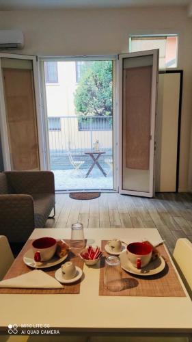 a table with plates and bowls on it in a living room at CASA SAVENA in Bologna