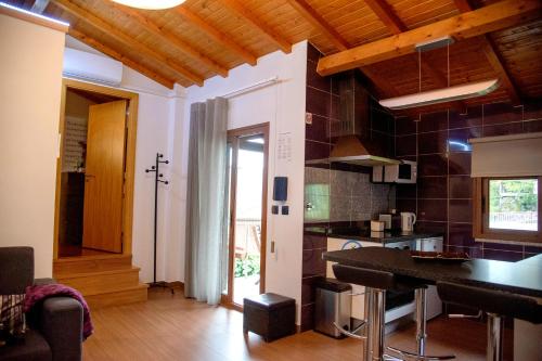 a kitchen with a table in a room at Casa da Fonte Gerês in Campo do Gerês