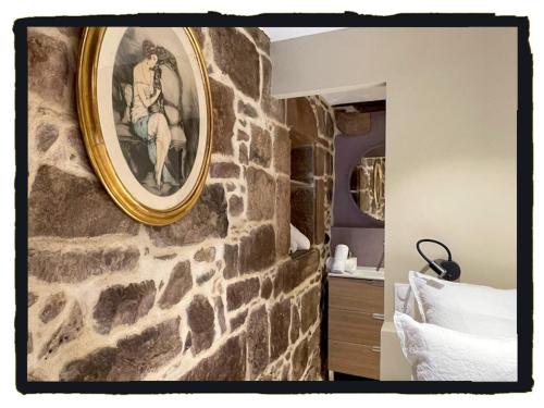 a painting of a man on a stone wall in a bedroom at Chambres d'Hôtes Maison E.Bernat in Saint-Jean-Pied-de-Port