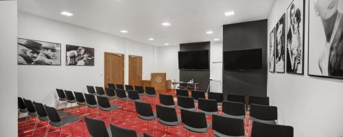 a conference room with black chairs and a table at Dioklecijan Hotel & Residence in Split