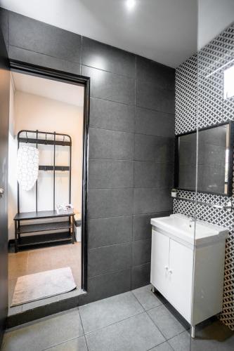 a bathroom with a mirror and a sink and a shower at Chulia Heritage Studio in George Town