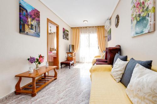 a living room with a couch and a table at Apartament Caballero de Rodas in Torrevieja
