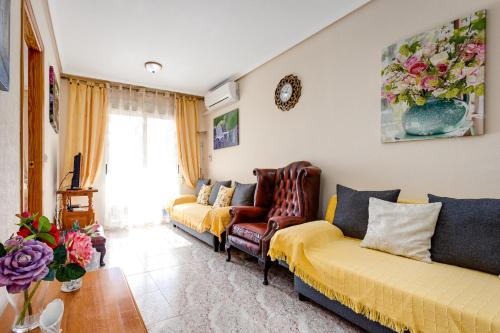 a living room with two couches and a table at Apartament Caballero de Rodas in Torrevieja