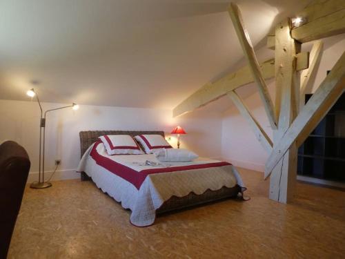 a bedroom with a large bed in a attic at exceptionnel loft style industriel tout équipé 15 personnes avec piscine et jacuzzi in Villebramar