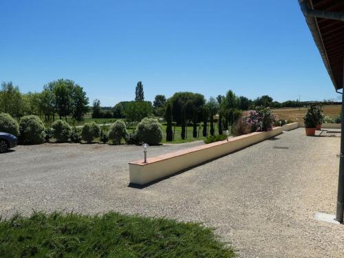a row of bushes and trees in a parking lot at exceptionnel loft style industriel tout équipé 15 personnes avec piscine et jacuzzi in Villebramar