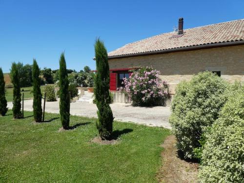 a group of cypress trees in front of a building at exceptionnel loft style industriel tout équipé 15 personnes avec piscine et jacuzzi in Villebramar