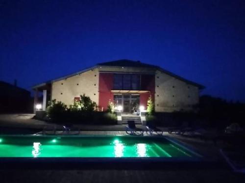 a house with a swimming pool at night at exceptionnel loft style industriel tout équipé 15 personnes avec jacuzzi in Villebramar