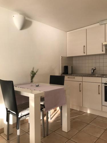 a kitchen with a table and chairs in a kitchen at Casa Conti al Lago in Ronco s/Ascona - Porto Ronco
