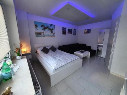 a bedroom with a bed and a purple light at Miami Apartment in Paderborn