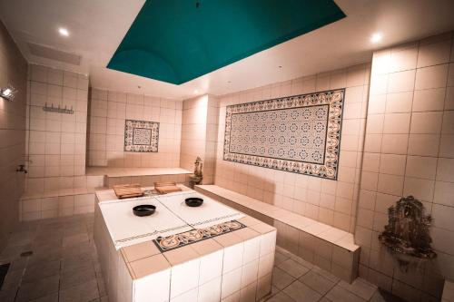 a bathroom with a sink in a room at Island Luxurious Suites Hotel and Spa in Netanya