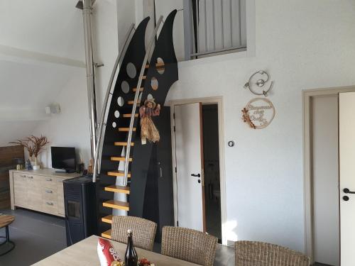a room with a large wall with a spiral staircase at Escape at Durbuy in Durbuy