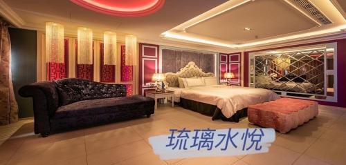 a bedroom with a bed and a chair and a couch at Shuiyue Boutique Motel in Dali