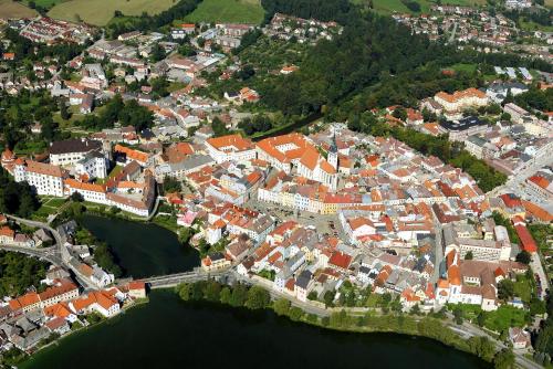 an overhead view of a city with buildings and water at Penzion Kasper Cyklopenzion in Jindrichuv Hradec