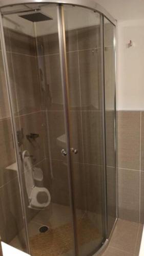 a glass shower in a bathroom with a toilet at Z SHOPPING LA GALERIA APT Great Location! Low price! Full amenities! in Asuncion