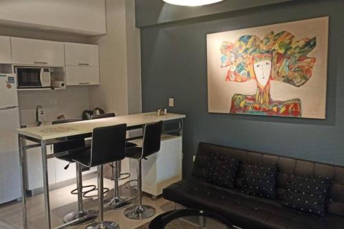 a living room with a table and chairs and a painting at Z SHOPPING LA GALERIA APT Great Location! Low price! Full amenities! in Asuncion
