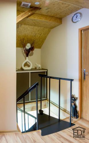 a staircase in a room with a wooden ceiling at Pokoje FreeDoor in Ługniany