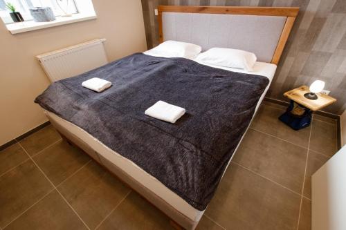 a bedroom with a bed with two towels on it at Saargemünder 128 in Saarbrücken