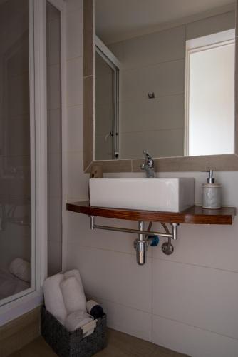 a bathroom with a white sink and a mirror at BO Hotel & Terraza in Valparaíso