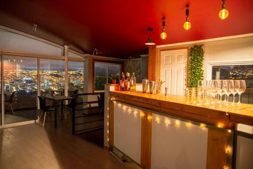 a bar in a restaurant with a view of the city at BO Hotel & Terraza in Valparaíso