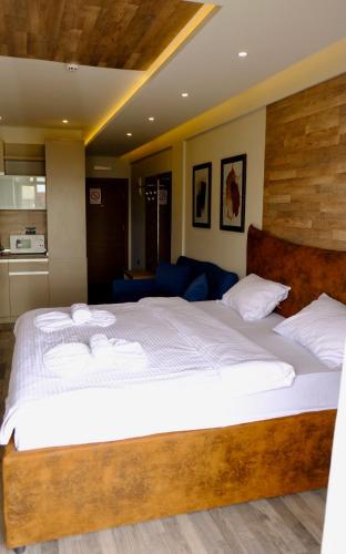 a bedroom with a large bed with white sheets at Milmari Premier 13 in Kopaonik