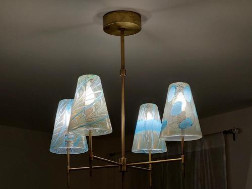 a chandelier with four glass pendants hanging from a ceiling at Residenza Donini in Venice Suite 1 in Venice