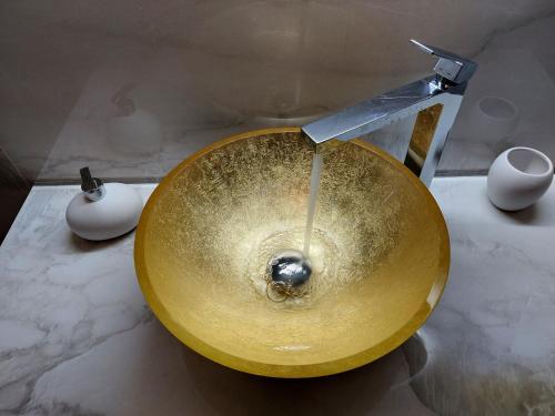 a gold sink in a bathroom with a faucet at Residenza Donini in Venice Suite 1 in Venice