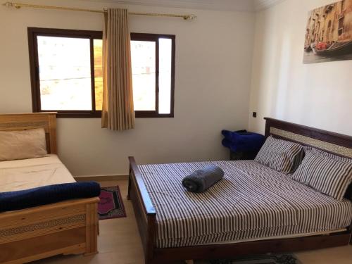 a bedroom with a bed with a bag on it at Imsouane Sunrise Apartments in Imsouane