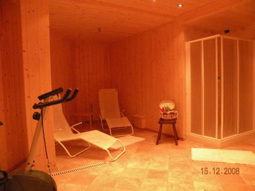 a room with two white chairs and a table at Hotel Bellevue in Champoluc
