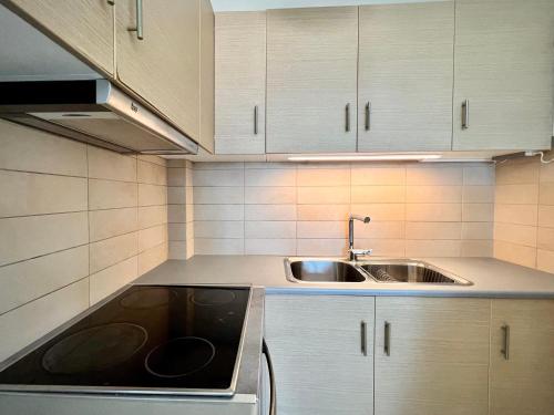 a kitchen with a sink and a counter top at Sunrise Studio with unhindered view to the sea. in Nea Makri