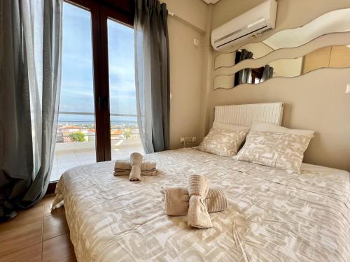a bedroom with a bed with two towels on it at Sunrise Studio with unhindered view to the sea. in Nea Makri