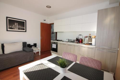 een keuken en een woonkamer met een tafel en een bank bij Classy Apartment Zagreb in Zagreb