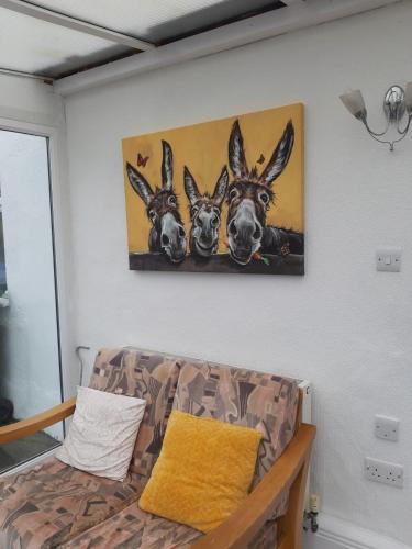 a painting of three deer hanging on a wall at Clare's Cottage in Miltown Malbay